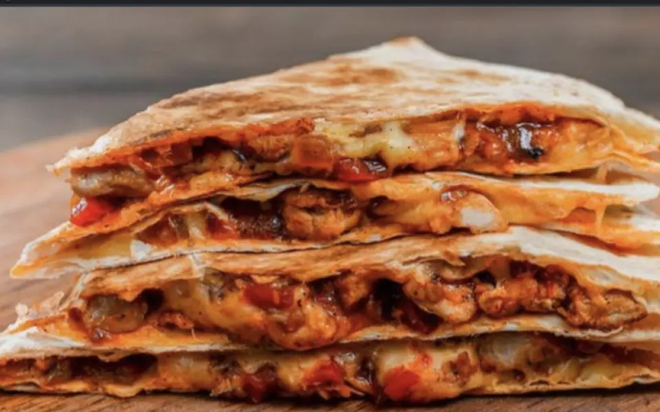 Toasted pita filled with egg and melted cheese, cut into wedges