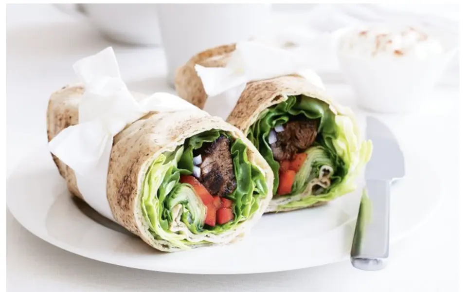 Pita filled with falafel and salad, cut in half